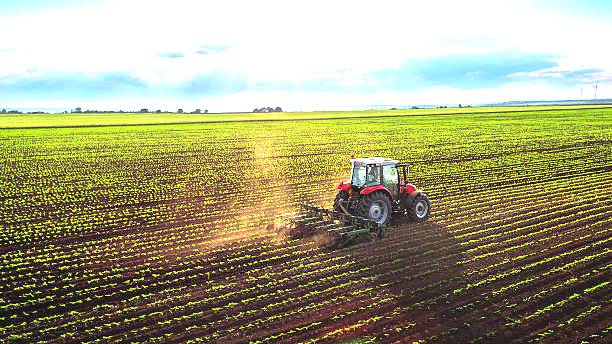 Tractor cultivating field at spring,aerial view